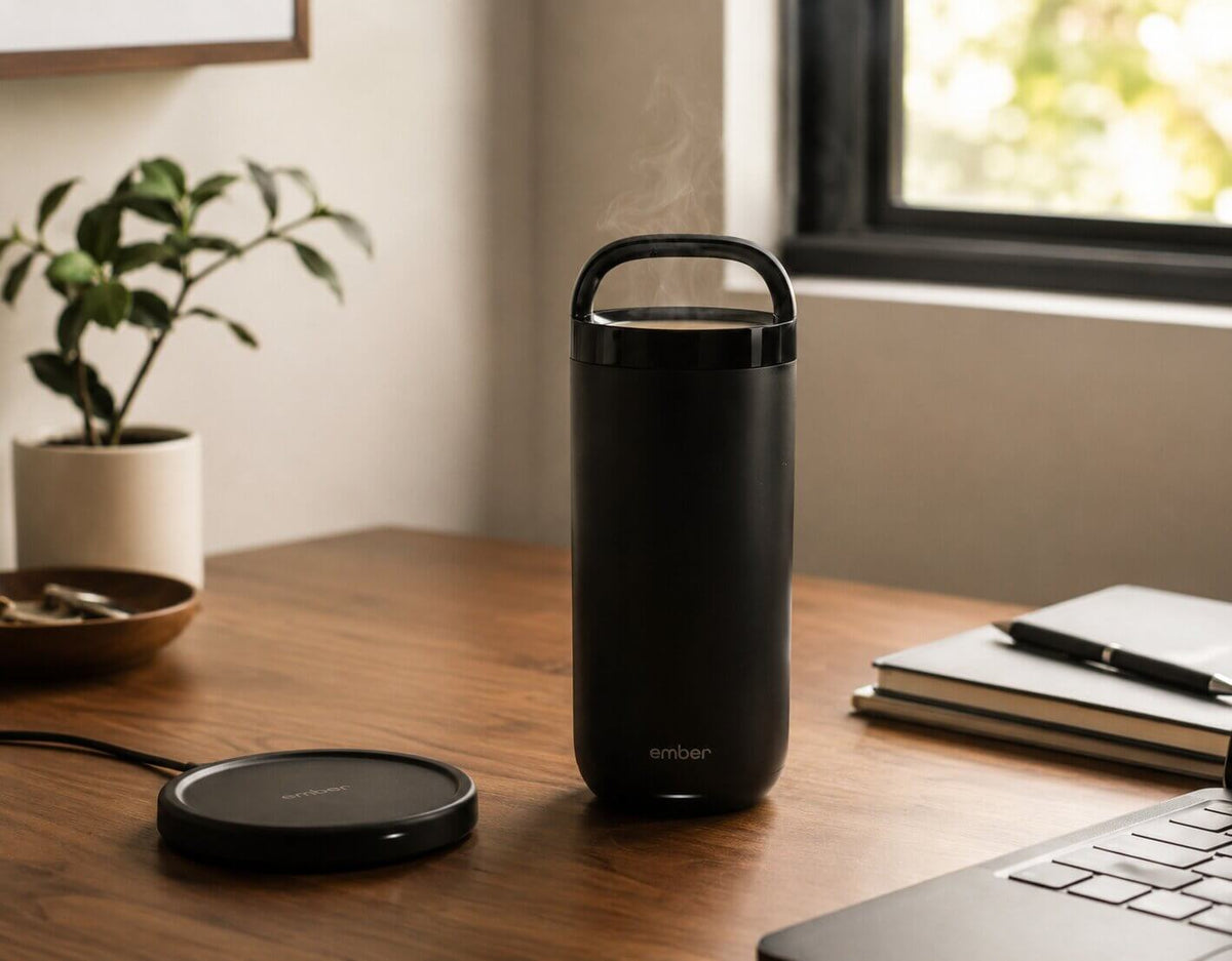 Ember 16 oz Temperature Control Tumbler keeping coffee hot away from the charging coaster