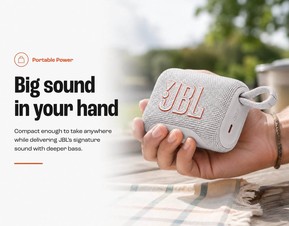 JBL Go 5 portable Bluetooth speaker held in one hand outdoors