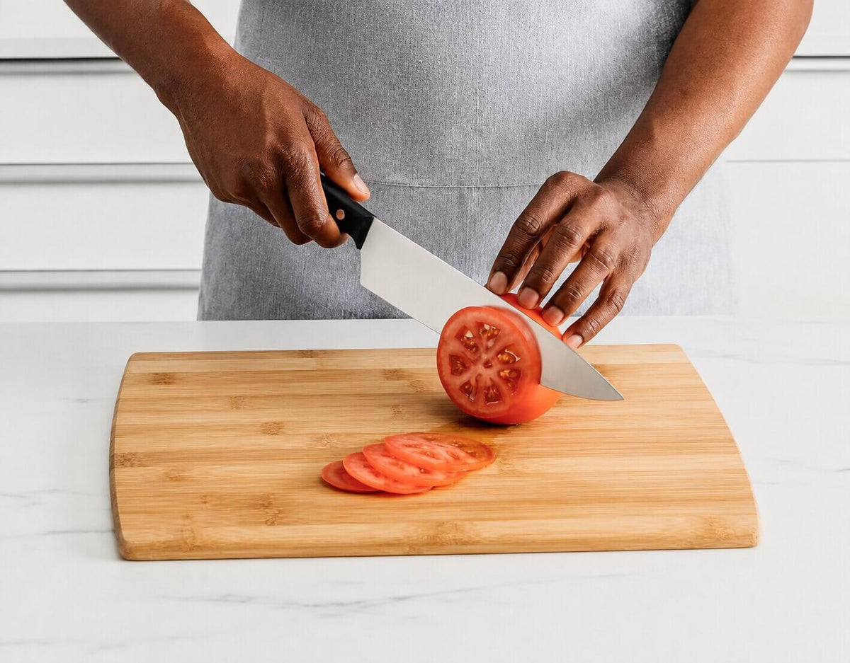Ninja NeverDull knife ergonomic black handle being used for food preparation